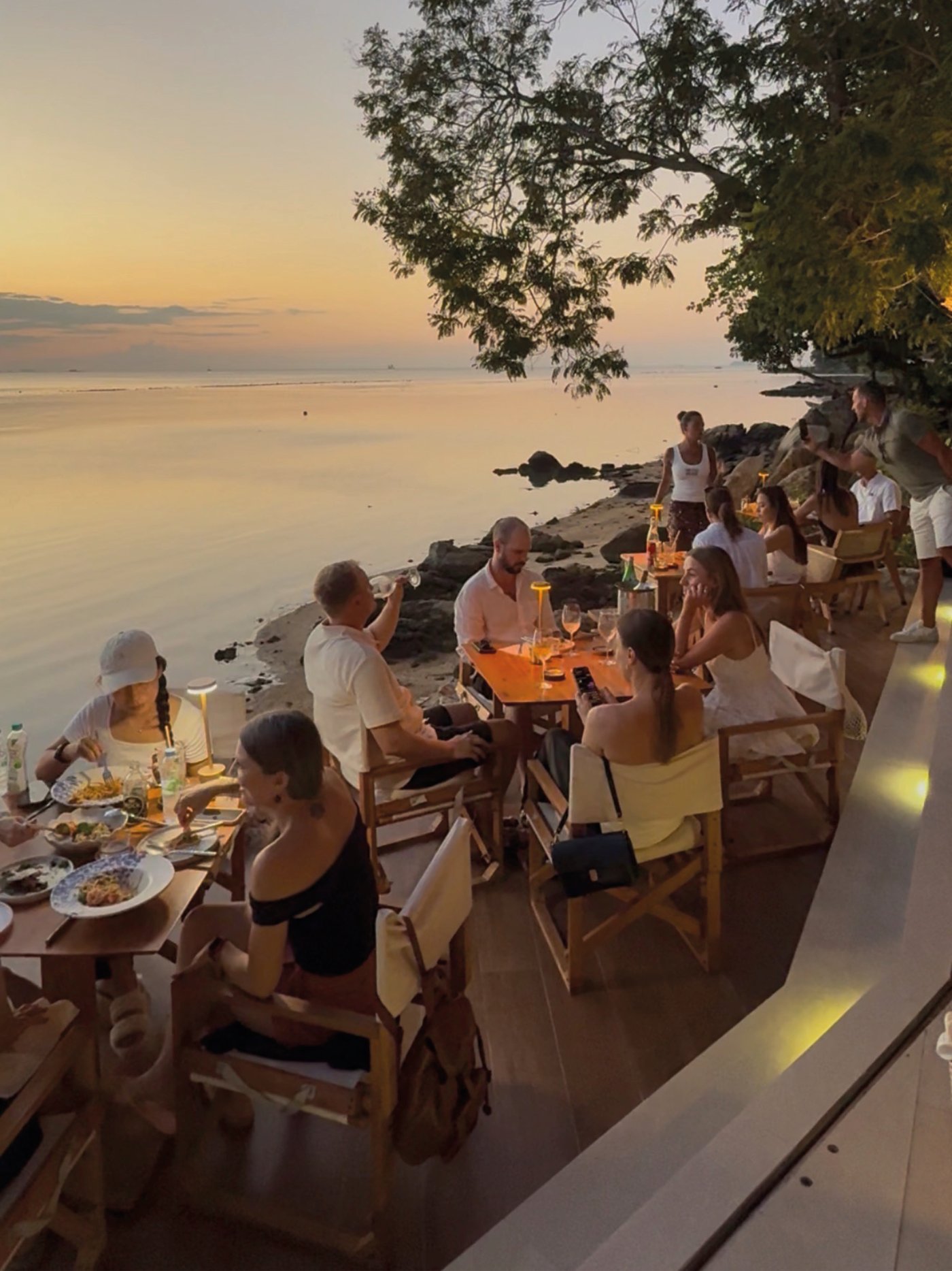 Guests dining at sunset on Nahm's waterfront terrace, Bangrak, Koh Samui